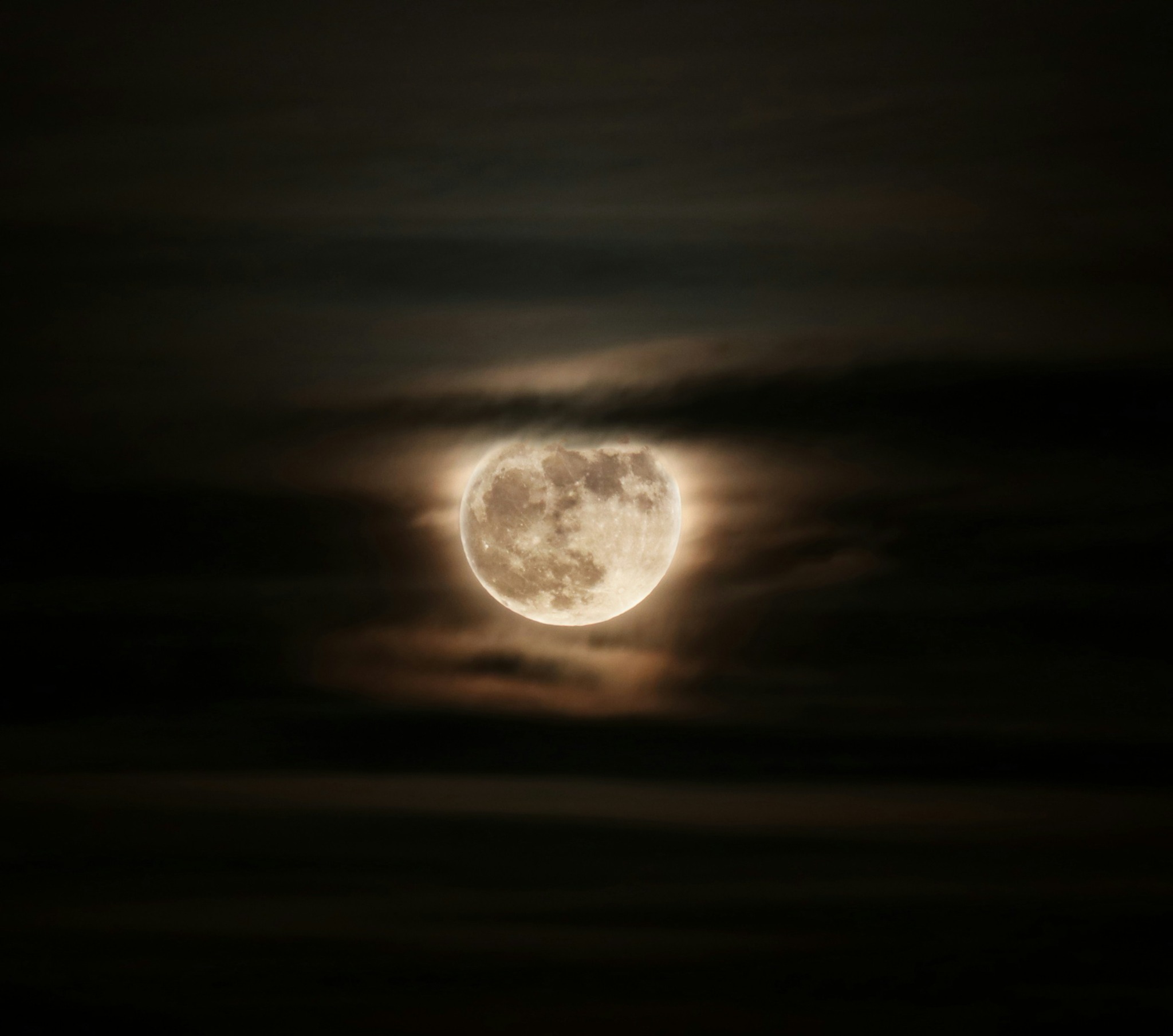 Under a Vernal Moon anthology artwork showing a full moon glowing through dark clouds